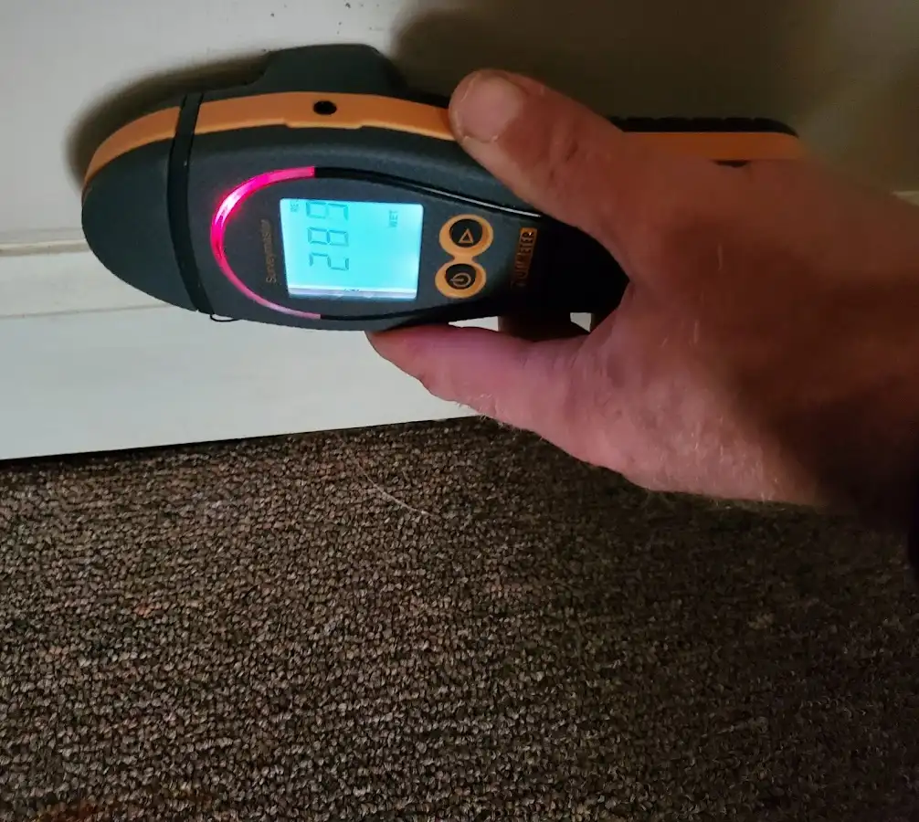 Moisture detection at baseboard during Storm Damage Restoration in El Mirage